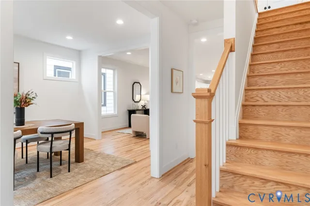 a dining room with furniture and wooden floor