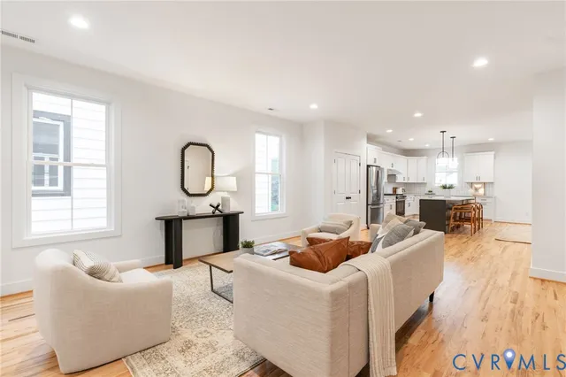 a large kitchen with kitchen island a large counter space dining table and stainless steel appliances