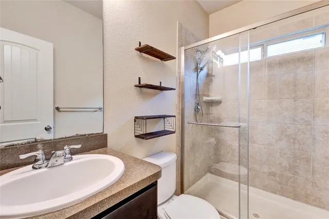 a bathroom with a sink toilet and shower