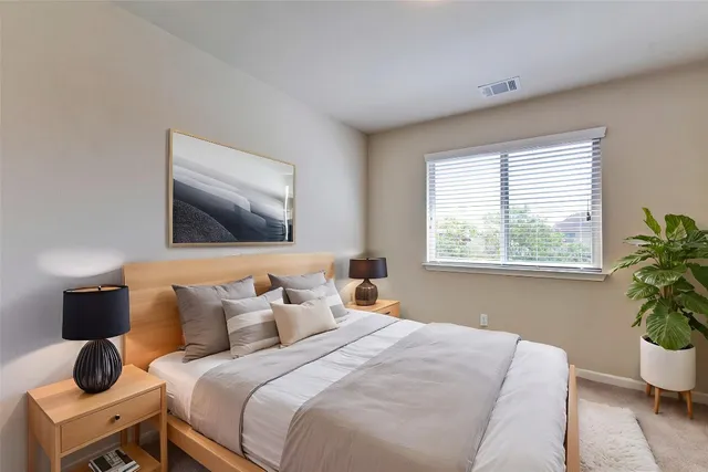 a bedroom with bed and window