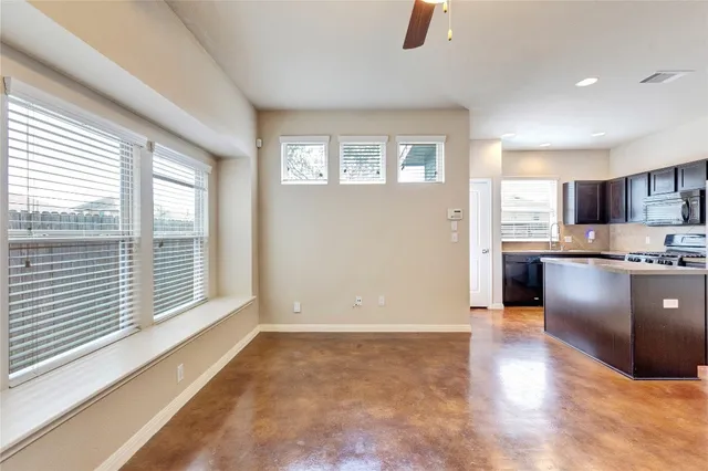 a view of a kitchen with wooden floor and a window
