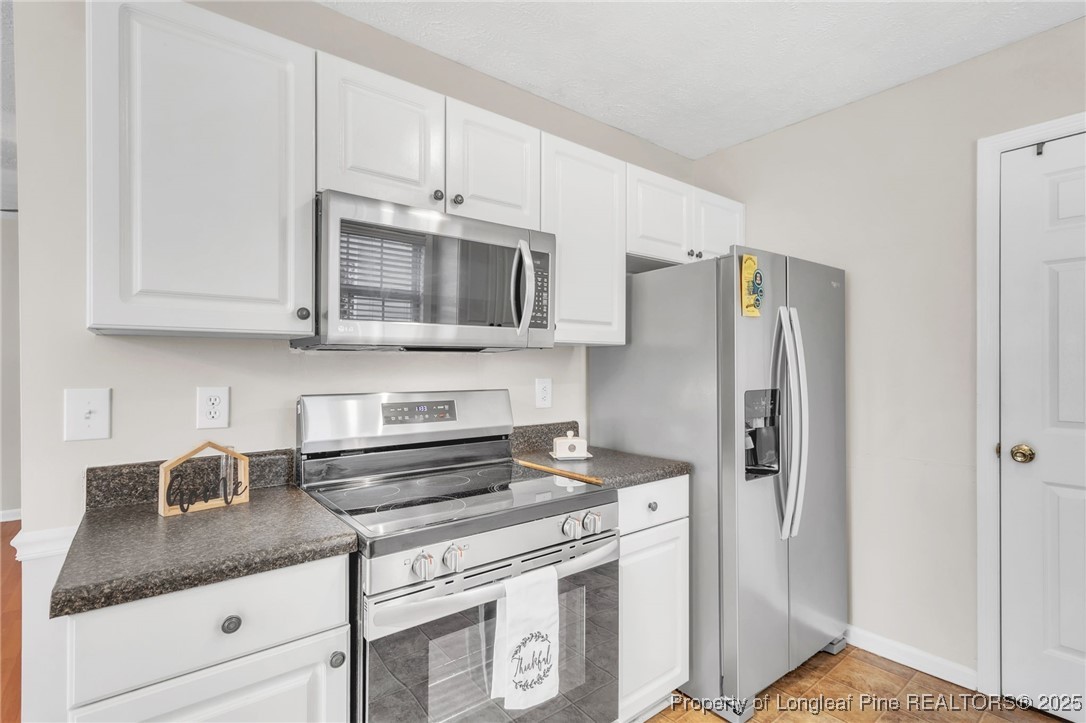 45 Ridgecrest Road Cameron, NC 28326 - Photo 12 of 32 a kitchen with granite countertop a refrigerator stove and microwave