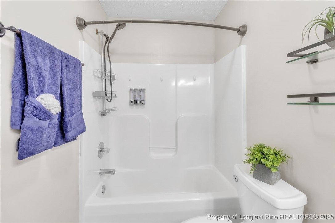 45 Ridgecrest Road Cameron, NC 28326 - Photo 17 of 32 a bathroom with a shower curtain and a window
