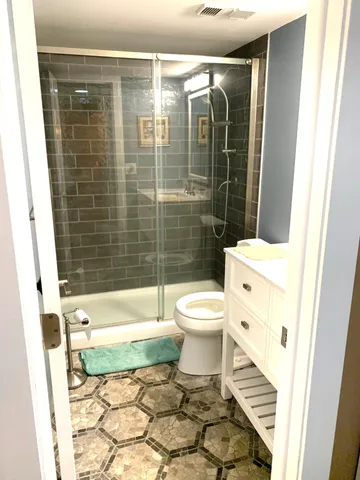 a bathroom with a toilet and a shower