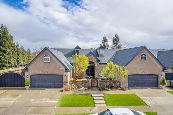 a front view of house with yard and green space