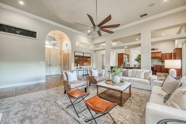 a kitchen with stainless steel appliances granite countertop a kitchen island a table and chairs in it