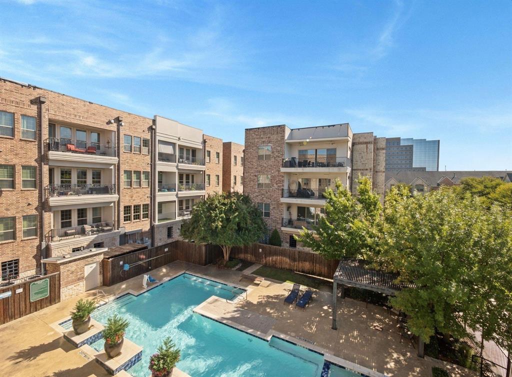 5001 Meridian Lane, Unit 2103 Addison, TX 75001 - Photo 23 of 26 Courtyard swimming pool with surrounding paver decking, mature trees, and privacy fencing