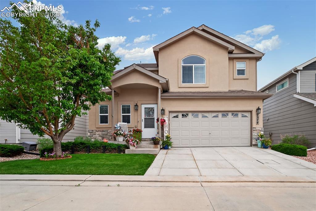 a front view of a house with a yard and garage