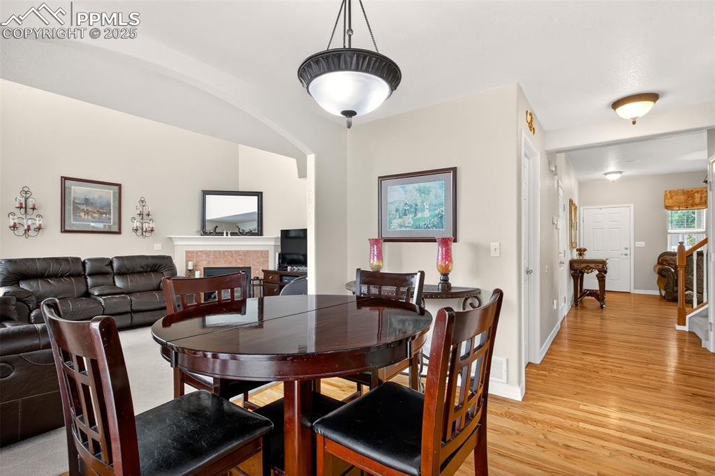 7374 Maybeck View Peyton, CO 80831 - Photo 11 of 38 a view of a dining room with furniture and wooden floor