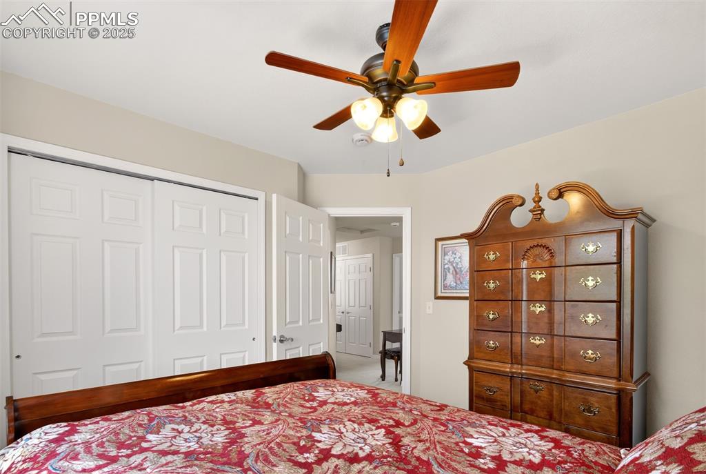7374 Maybeck View Peyton, CO 80831 - Photo 24 of 38 a bedroom with a bed and a dresser in it