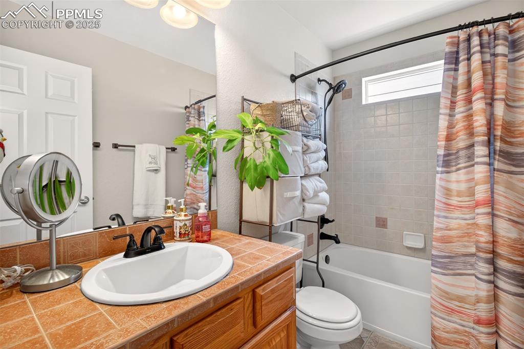 7374 Maybeck View Peyton, CO 80831 - Photo 25 of 38 a bathroom with a sink toilet and shower