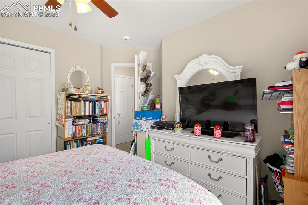 7374 Maybeck View Peyton, CO 80831 - Photo 27 of 38 a bedroom with a bed and a flat screen tv