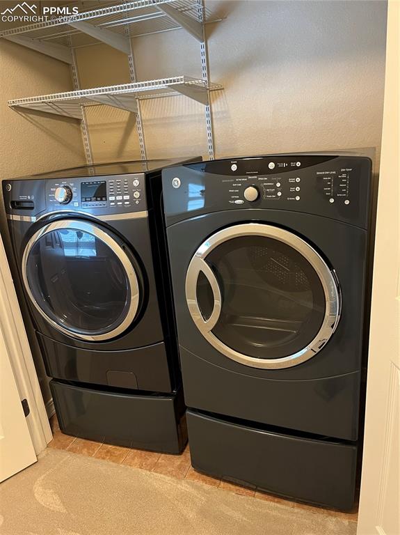 7374 Maybeck View Peyton, CO 80831 - Photo 28 of 38 a utility room with dryer and washer