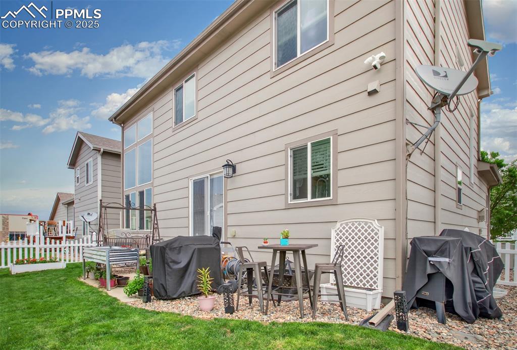 7374 Maybeck View Peyton, CO 80831 - Photo 33 of 38 a view of a patio with table and chairs and potted plants