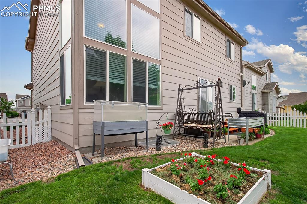 7374 Maybeck View Peyton, CO 80831 - Photo 34 of 38 a view of backyard with a garden and seating area