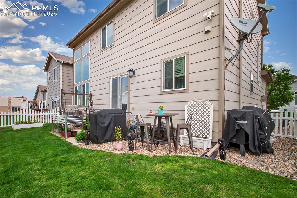 7374 Maybeck View Peyton, CO 80831 - Photo 35 of 38 a view of a chair and table back yard of the house