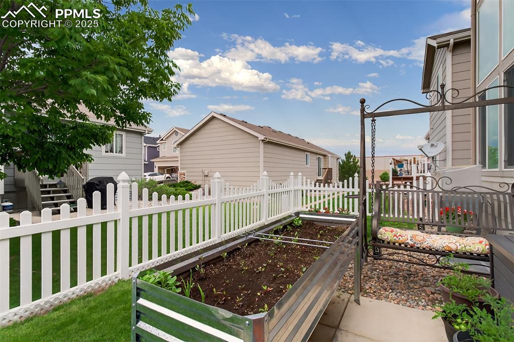 7374 Maybeck View Peyton, CO 80831 - Photo 36 of 38 a view of a wooden deck with a yard