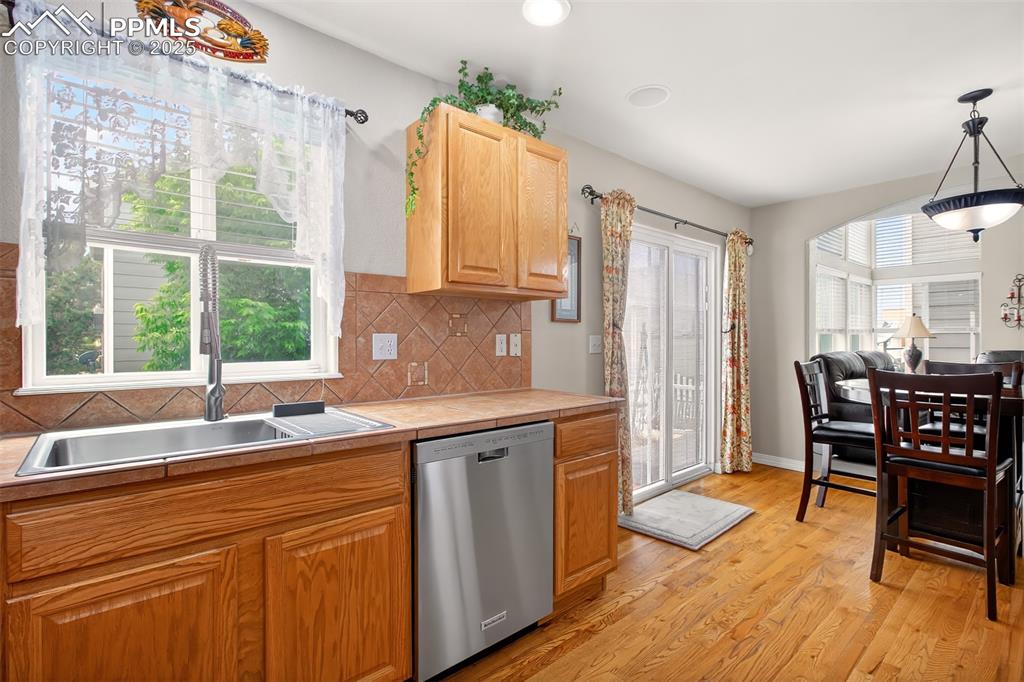 7374 Maybeck View Peyton, CO 80831 - Photo 7 of 38 a kitchen with a sink and wooden cabinets