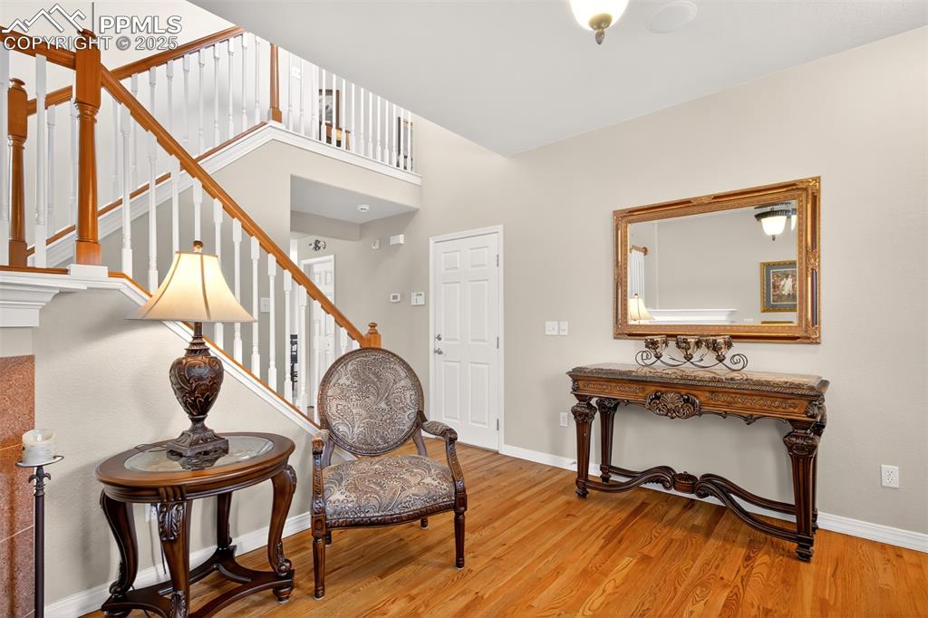 7374 Maybeck View Peyton, CO 80831 - Photo 10 of 38 a view of hall way with furniture and paintings on the wall