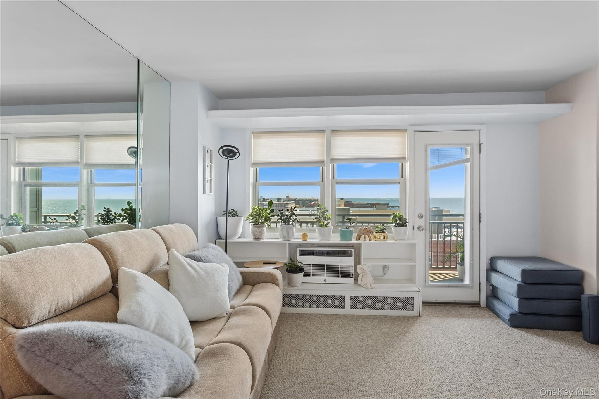25 Neptune Boulevard, Unit 9S Long Beach, NY 11561 - Photo 11 of 21 a living room with furniture and a large window
