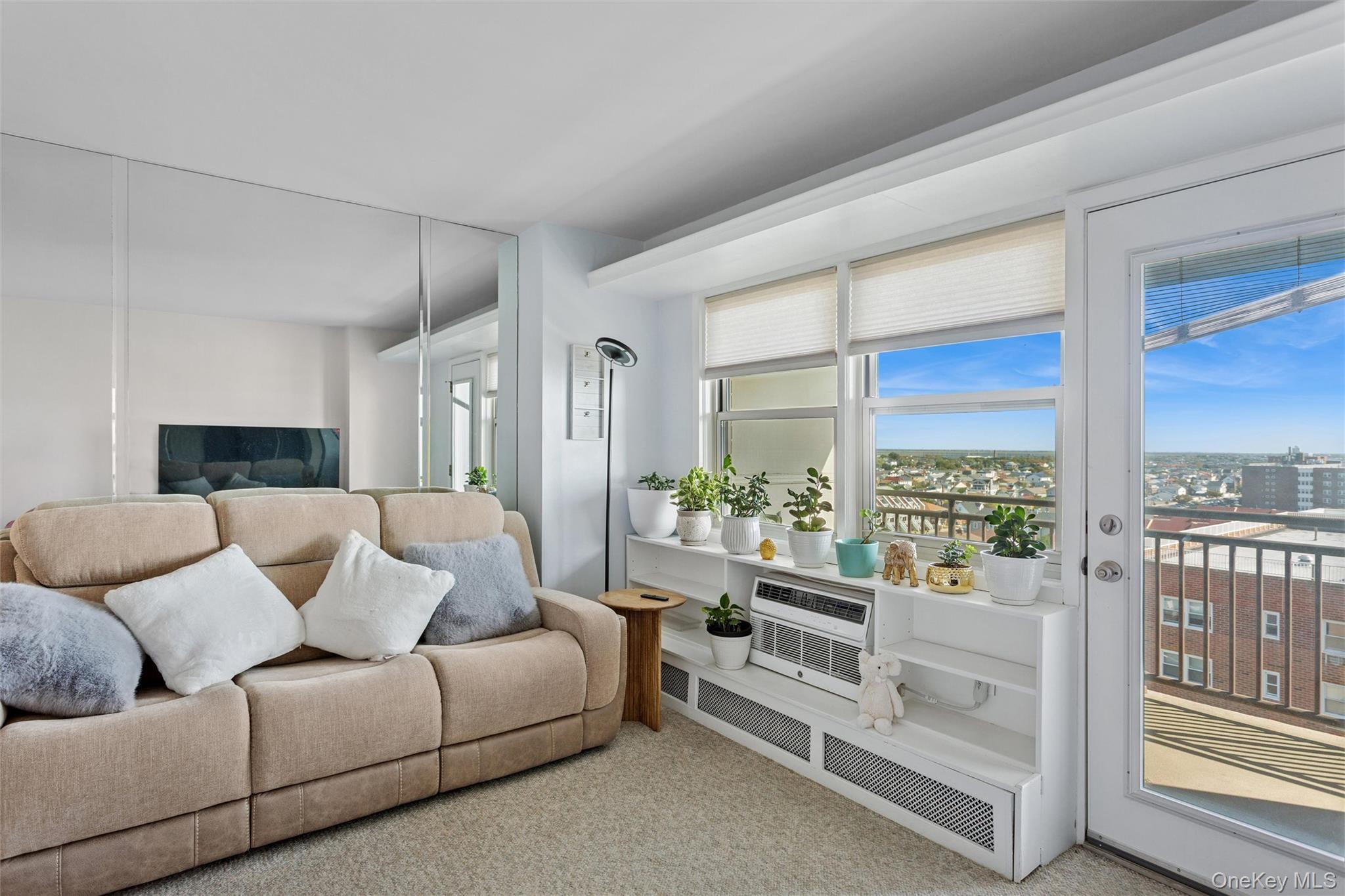 25 Neptune Boulevard, Unit 9S Long Beach, NY 11561 - Photo 12 of 21 a living room with furniture and a large window