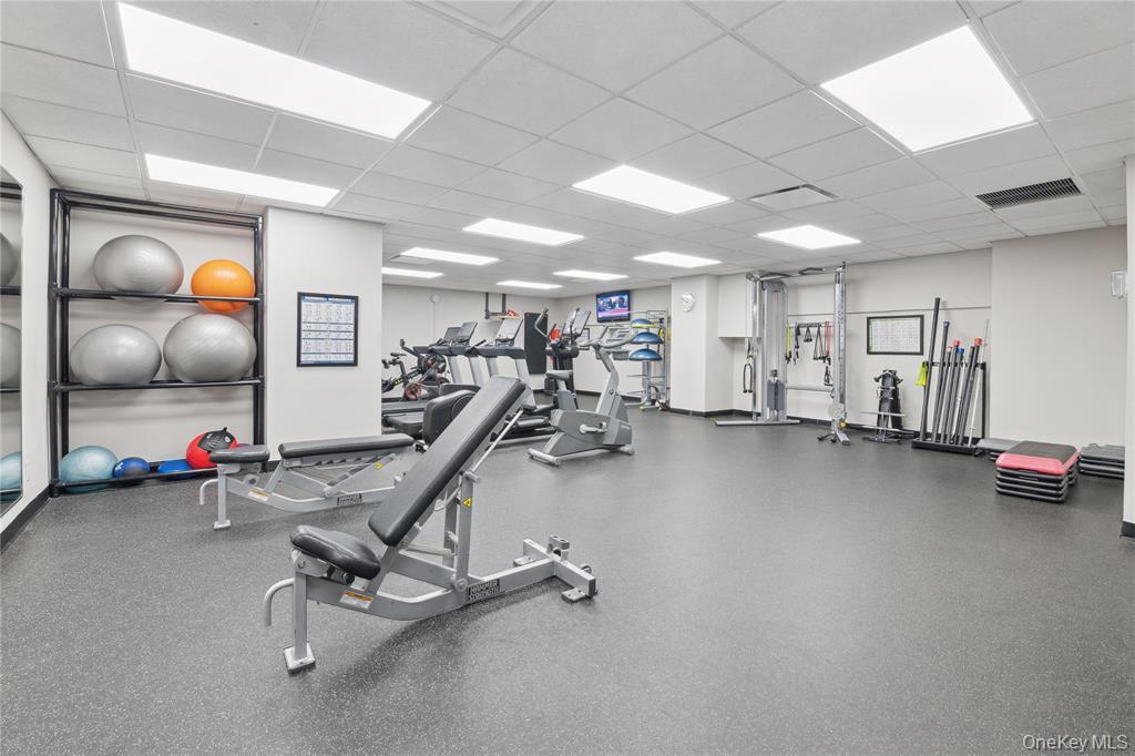 25 Neptune Boulevard, Unit 9S Long Beach, NY 11561 - Photo 17 of 21 a view of a room with gym equipment