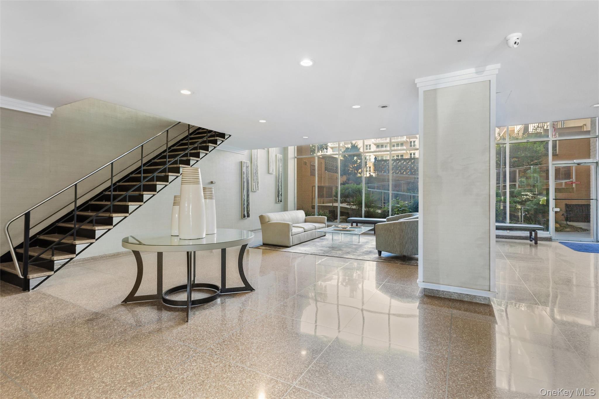 25 Neptune Boulevard, Unit 9S Long Beach, NY 11561 - Photo 4 of 21 a living room with furniture and a floor to ceiling window