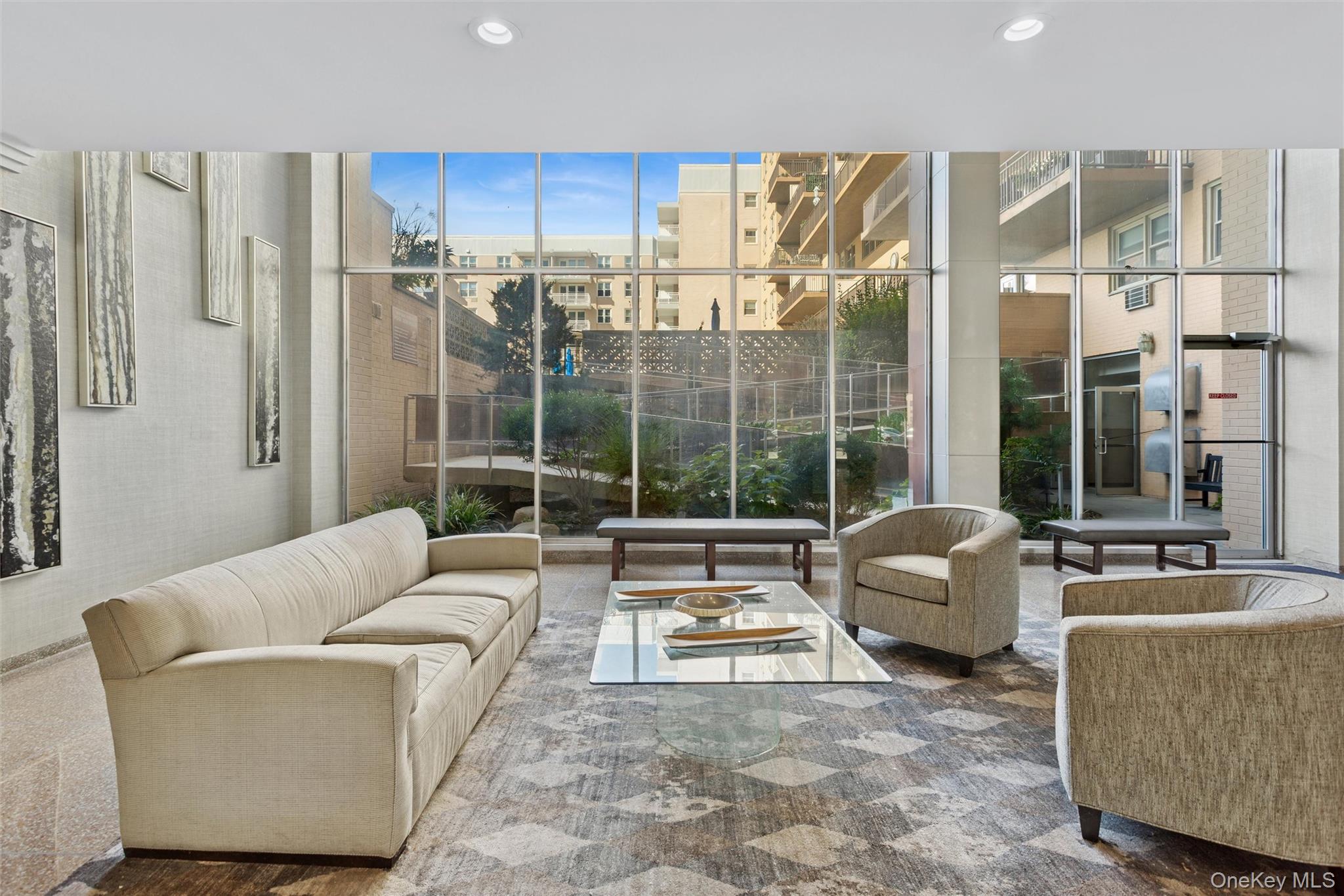 25 Neptune Boulevard, Unit 9S Long Beach, NY 11561 - Photo 5 of 21 a living room with furniture and a large window