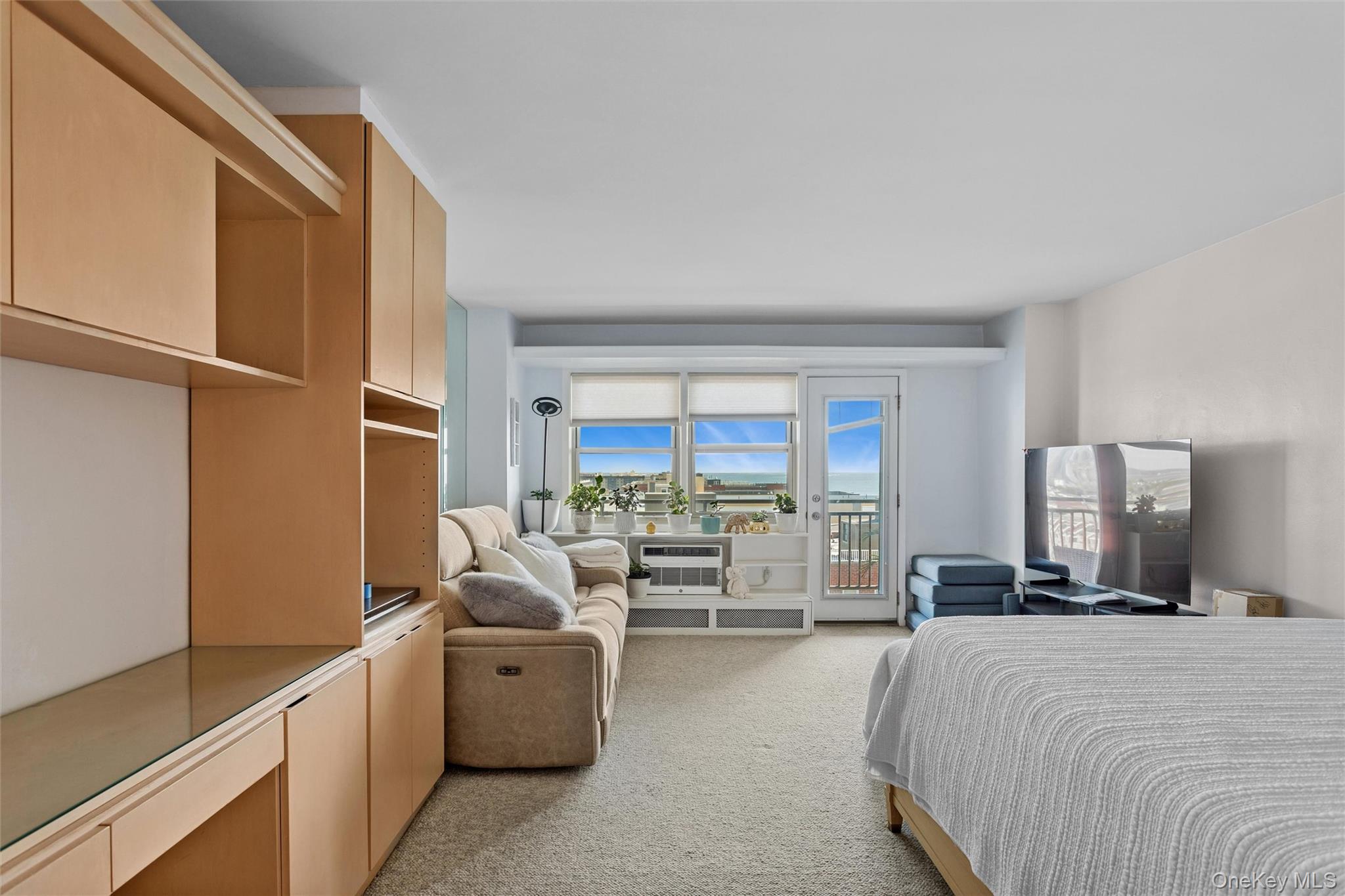 25 Neptune Boulevard, Unit 9S Long Beach, NY 11561 - Photo 6 of 21 a bed room with a bed and a large window