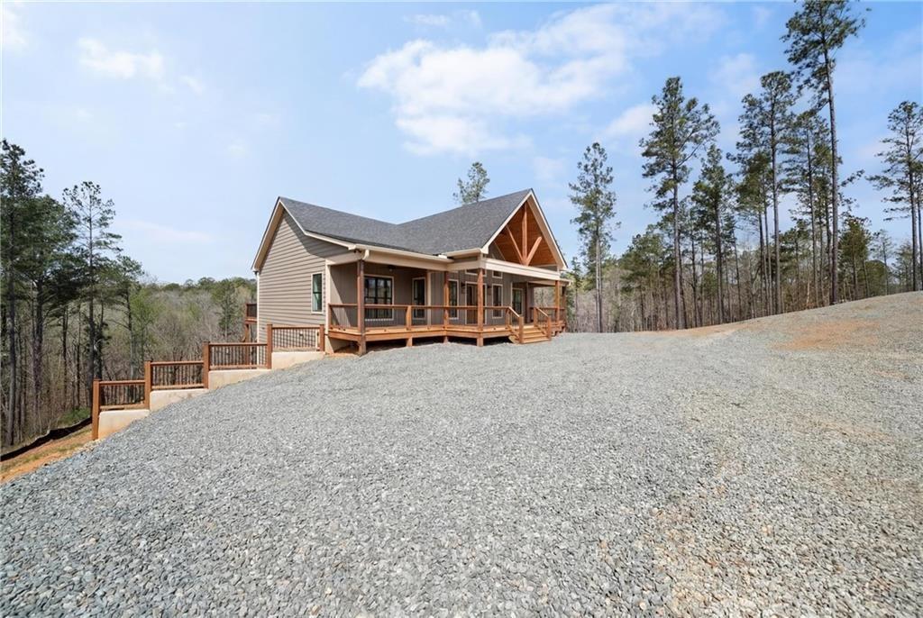2956 Blalock Mountain Road Talking Rock, GA 30175 - Photo 43 of 63 a front view of a house with a yard and balcony