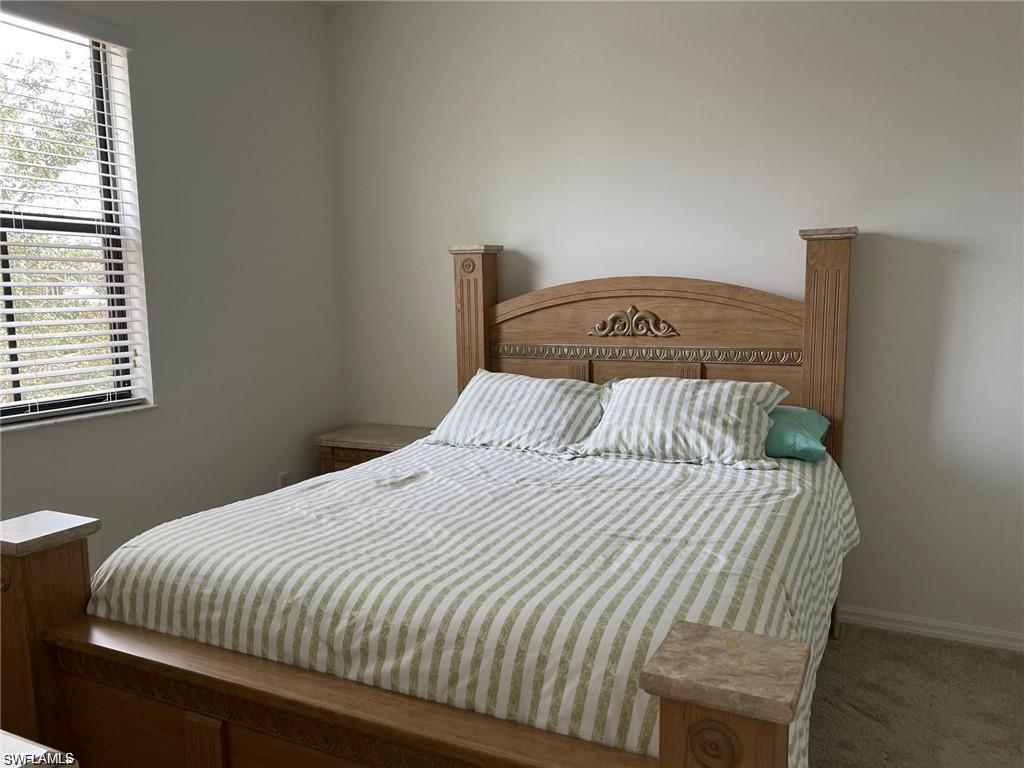 5293 Beckton Road Ave Maria, FL 34142 - Photo 12 of 17 a bedroom with a bed and a window