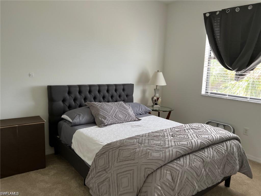 5293 Beckton Road Ave Maria, FL 34142 - Photo 13 of 17 a bed sitting in a bedroom next to a window