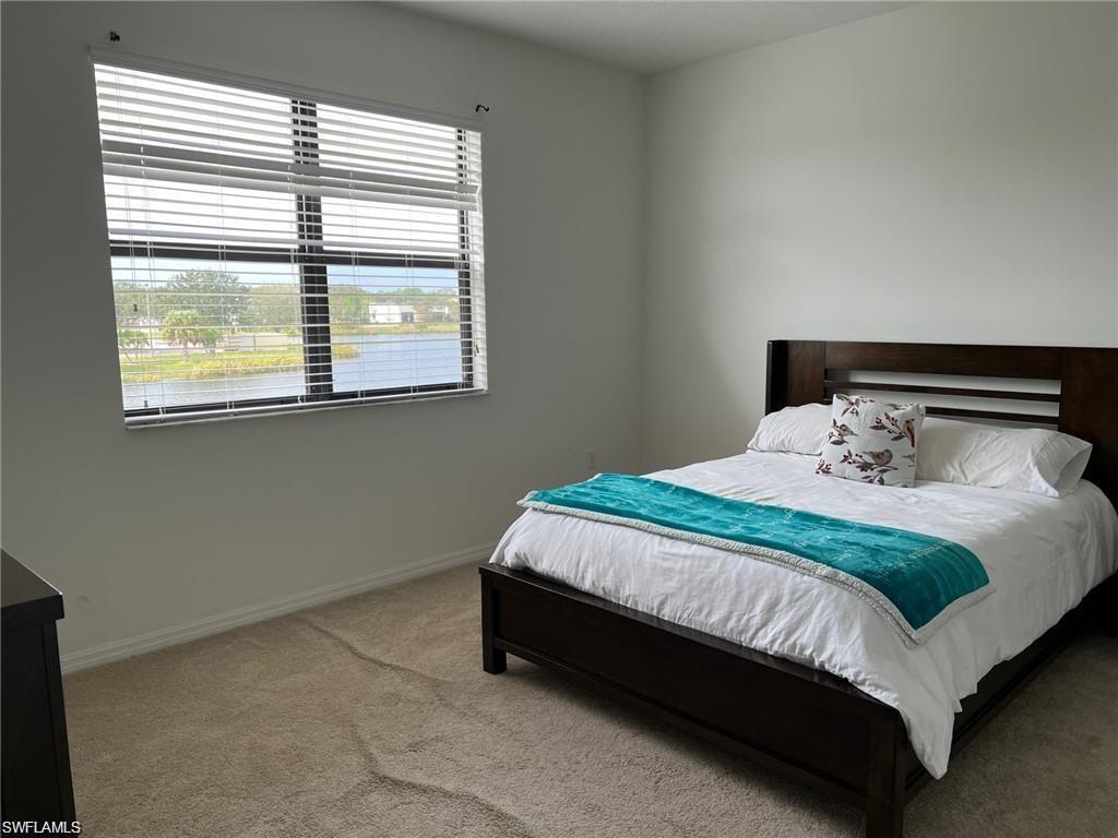 5293 Beckton Road Ave Maria, FL 34142 - Photo 15 of 17 a bed sitting in a bedroom next to a window