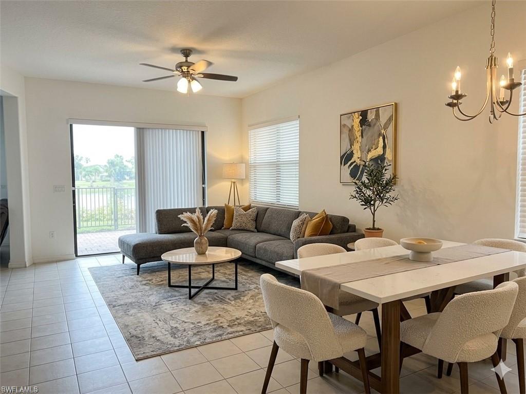 5293 Beckton Road Ave Maria, FL 34142 - Photo 2 of 17 a living room with furniture and a chandelier