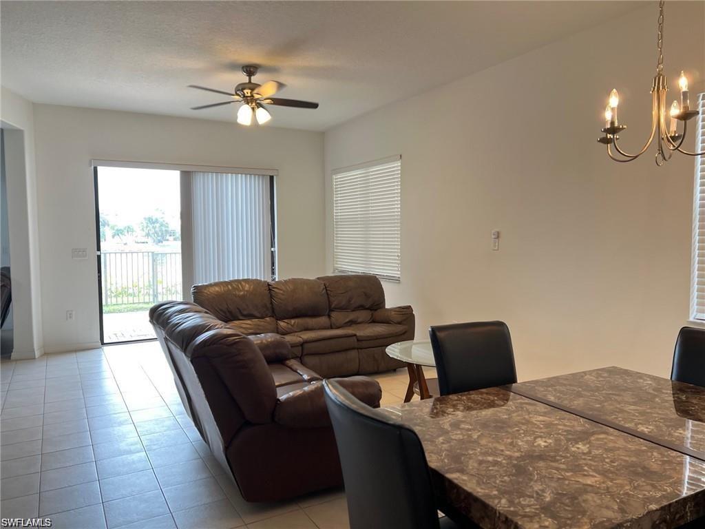 5293 Beckton Road Ave Maria, FL 34142 - Photo 9 of 17 a living room with furniture and a chandelier