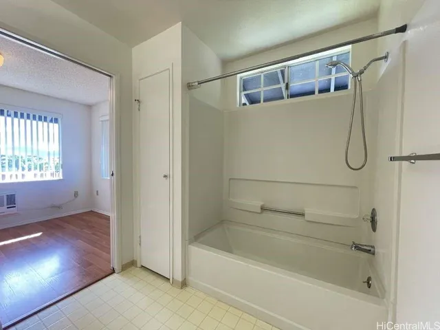 a bathroom with a bathtub and a shower