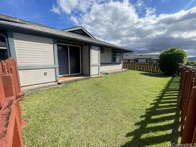 a view of a house with backyard and porch