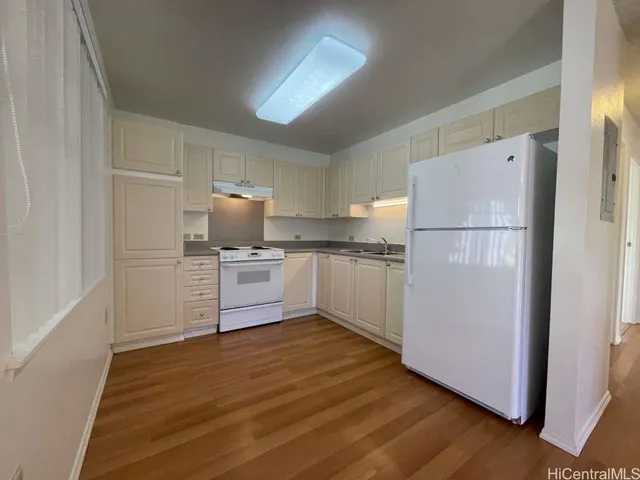 a kitchen with white cabinets and white appliances