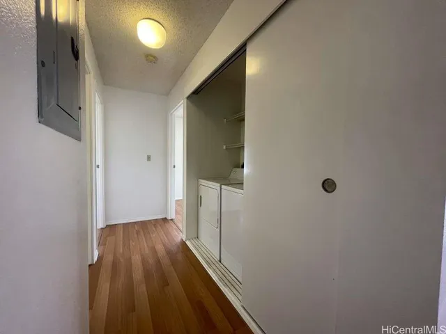 a view of hallway with wooden floor