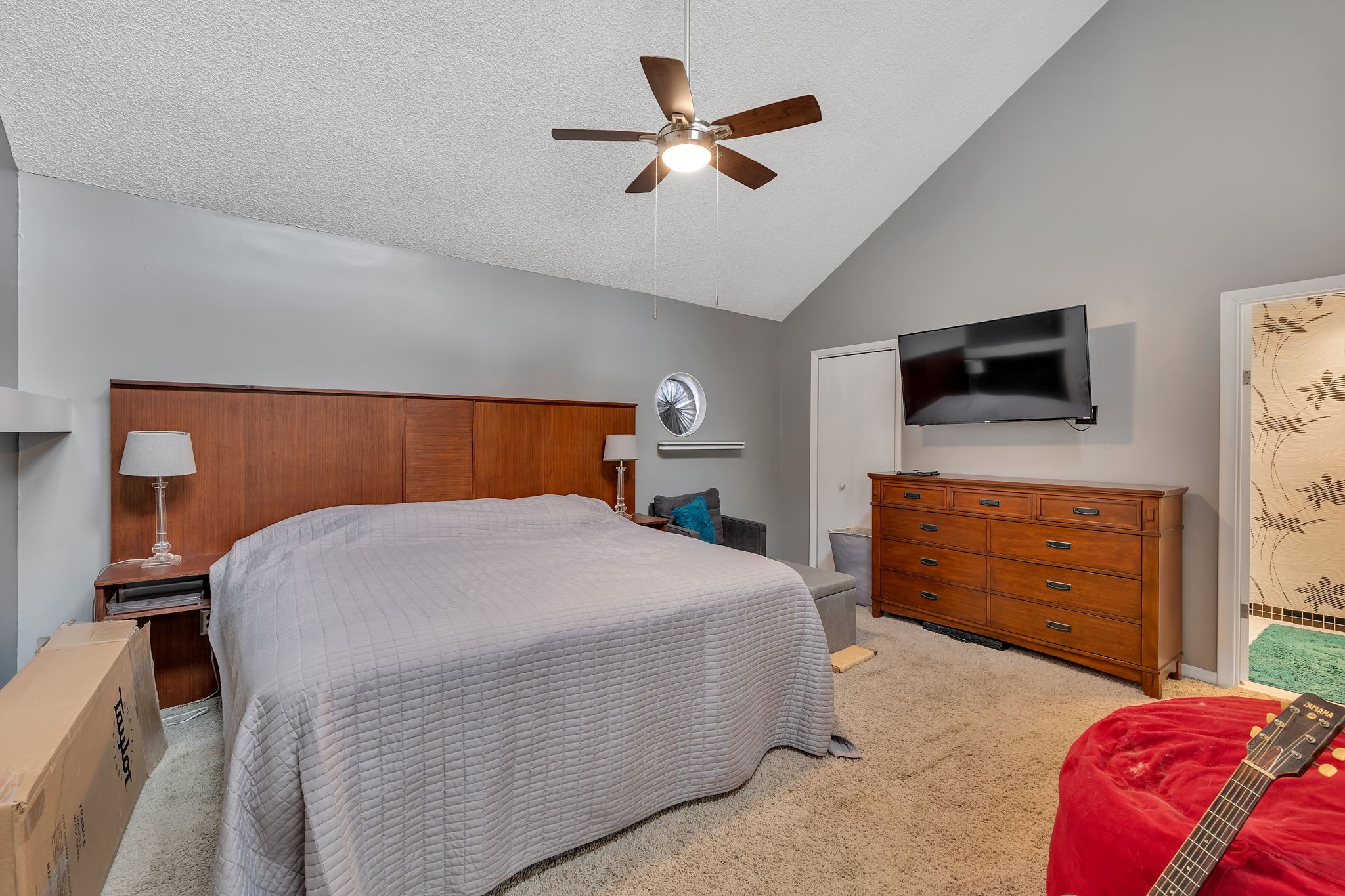 214 Harpers Mill Road Hermitage, TN 37076 - Photo 31 of 42 a bedroom with a bed a dresser and a chandelier