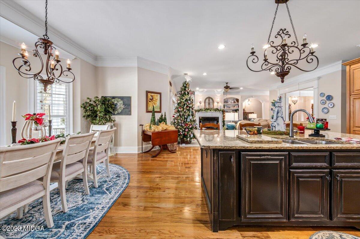 60 Walden Road Forsyth, GA 31029 - Photo 12 of 31 a view of a dining room with furniture a chandelier and wooden floor