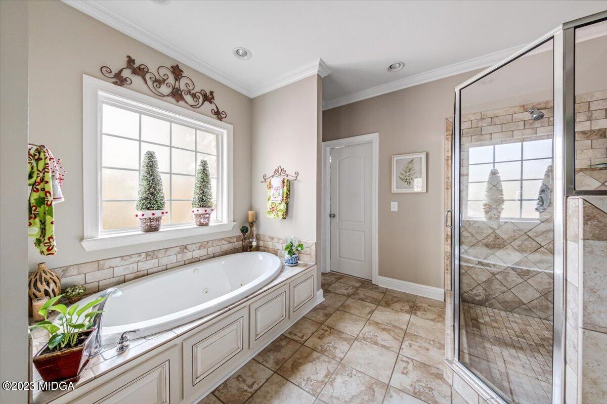 60 Walden Road Forsyth, GA 31029 - Photo 16 of 31 a bathroom with a bathtub a shower and a sink