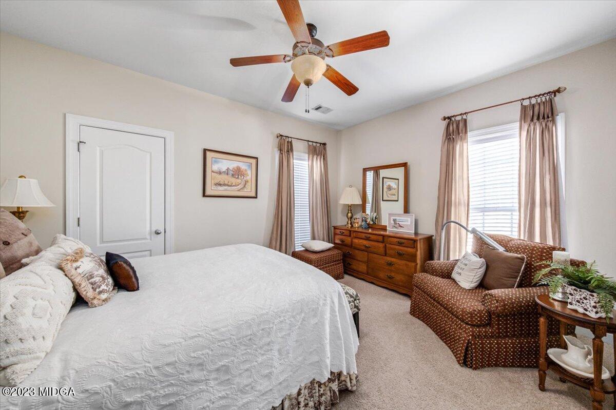 60 Walden Road Forsyth, GA 31029 - Photo 18 of 31 a spacious bedroom with a bed couch and windows