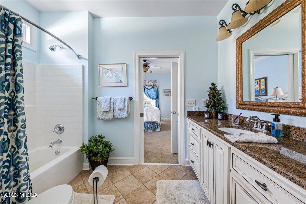 60 Walden Road Forsyth, GA 31029 - Photo 21 of 31 a spacious bathroom with a granite countertop tub sink and mirror