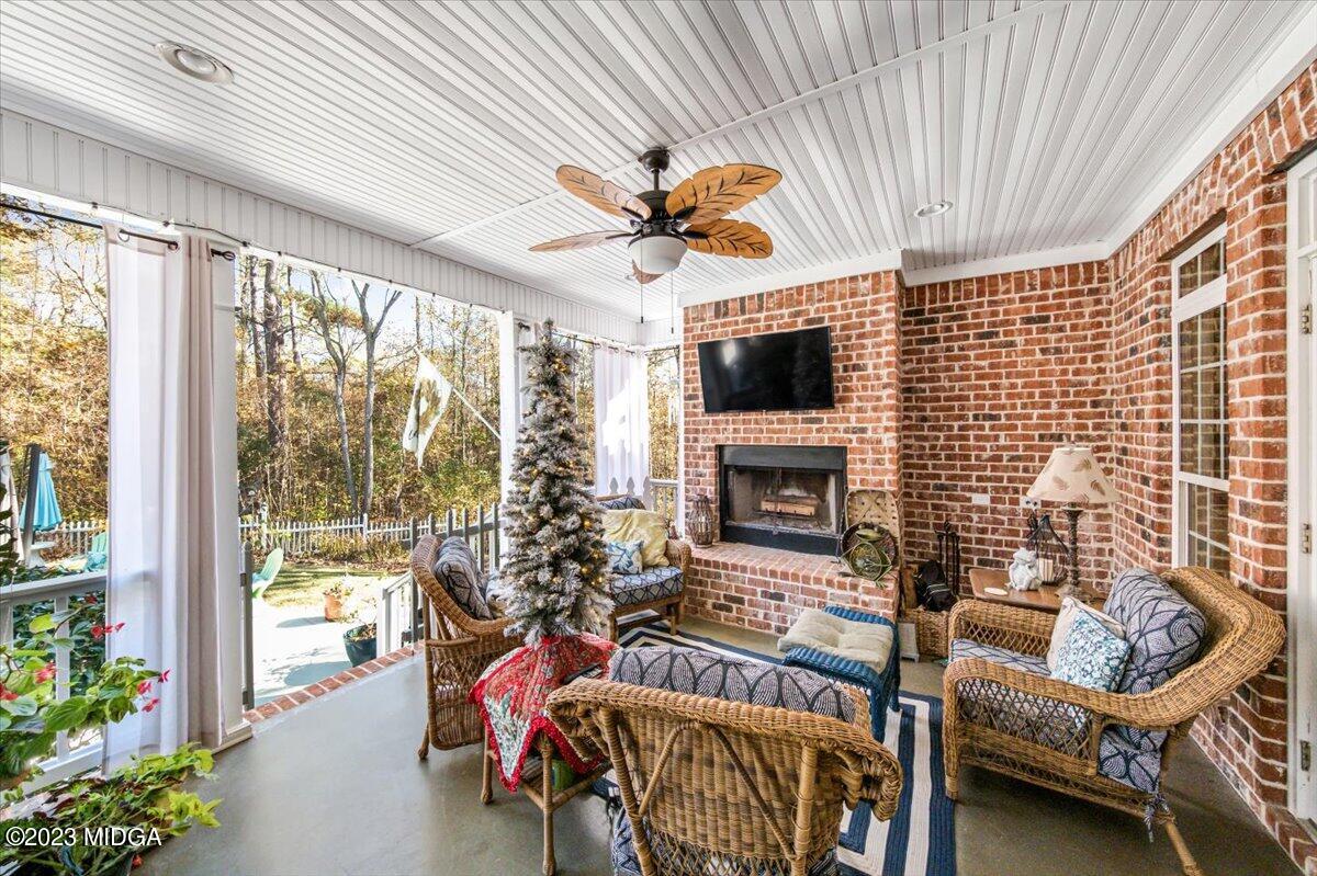 60 Walden Road Forsyth, GA 31029 - Photo 24 of 31 a living room with furniture a fireplace and a floor to ceiling window