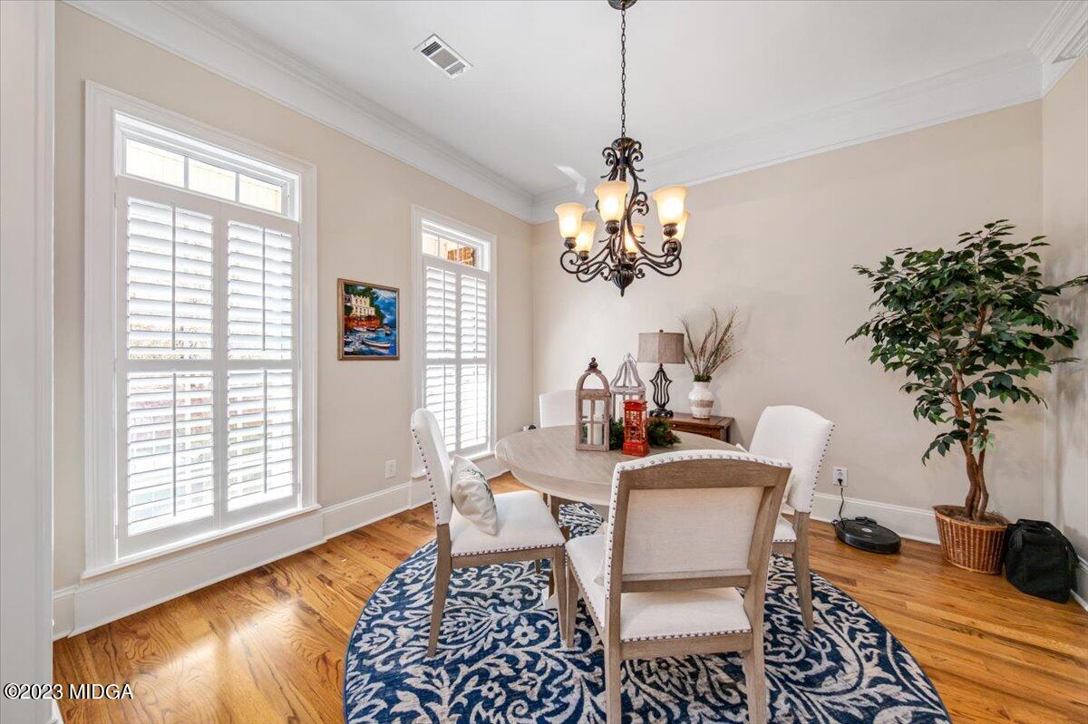 60 Walden Road Forsyth, GA 31029 - Photo 3 of 31 a dining room with furniture a rug a potted plant and a chandelier