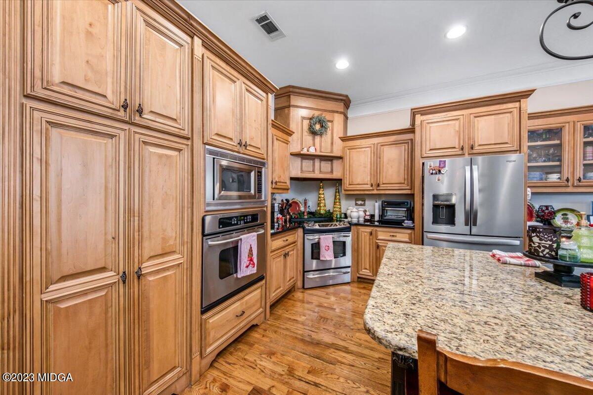 60 Walden Road Forsyth, GA 31029 - Photo 9 of 31 a kitchen with stainless steel appliances granite countertop a refrigerator a stove and a sink