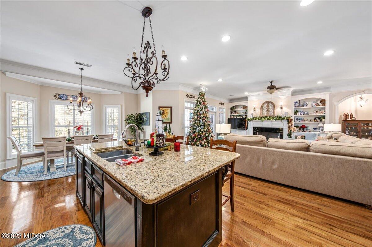 60 Walden Road Forsyth, GA 31029 - Photo 10 of 31 a living room with kitchen island granite countertop furniture and a chandelier