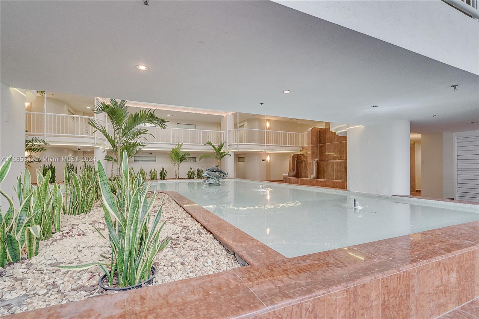 Omni Miami, FL 33132 - Photo 13 of 51 a view of a living room and floor to ceiling window and potted plants