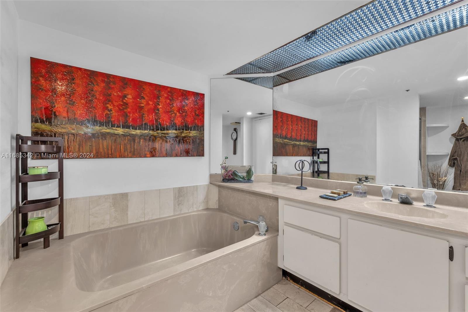 Omni Miami, FL 33132 - Photo 32 of 51 a bathroom with a tub a double vanity sink and mirror